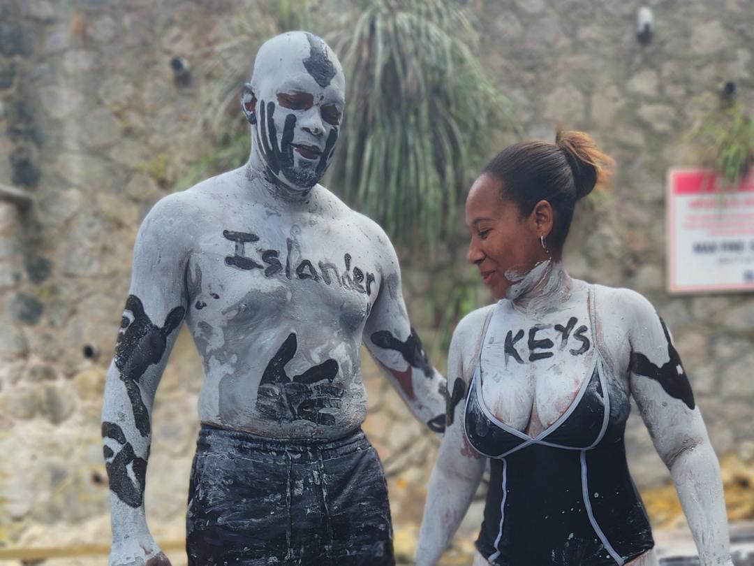 My wife and I are posing for photos while covered in mud at the Sulphur Springs in St. Lucia.