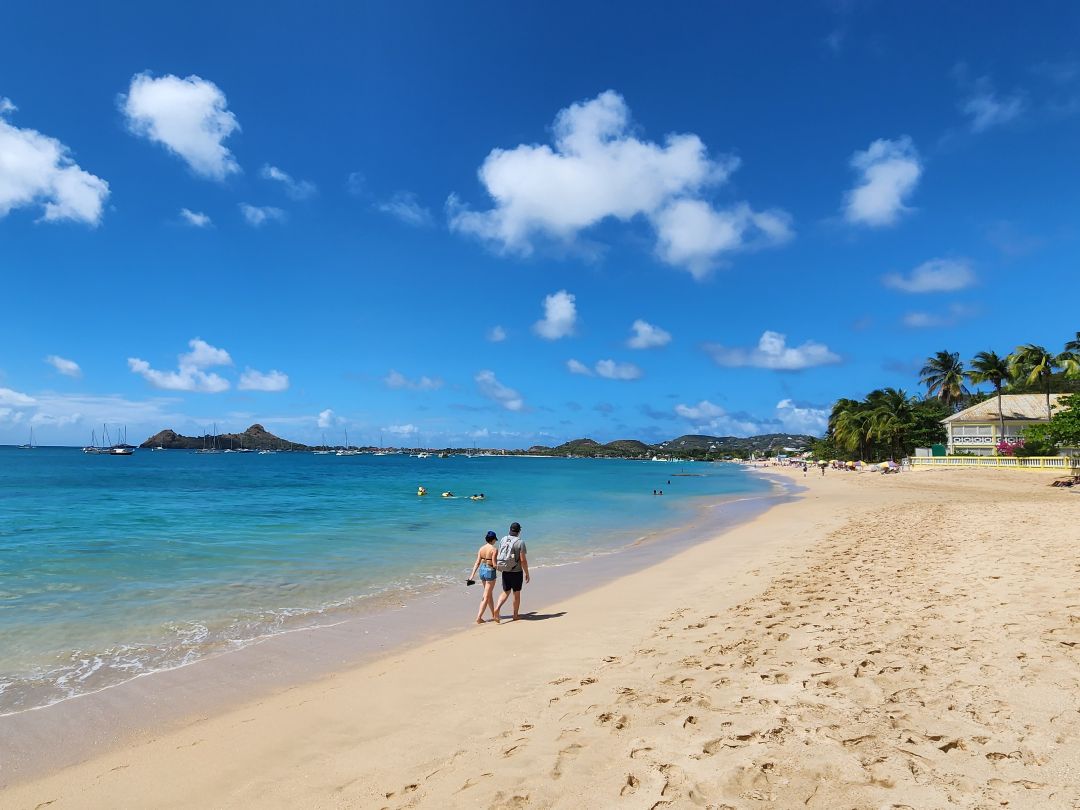 Guests walking on Reduit beach in St. Lucia