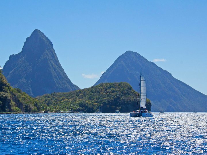 Majestic twin volcanic peaks of Gros Piton and Petit Piton rising dramatically from the Caribbean Sea in St. Lucia.