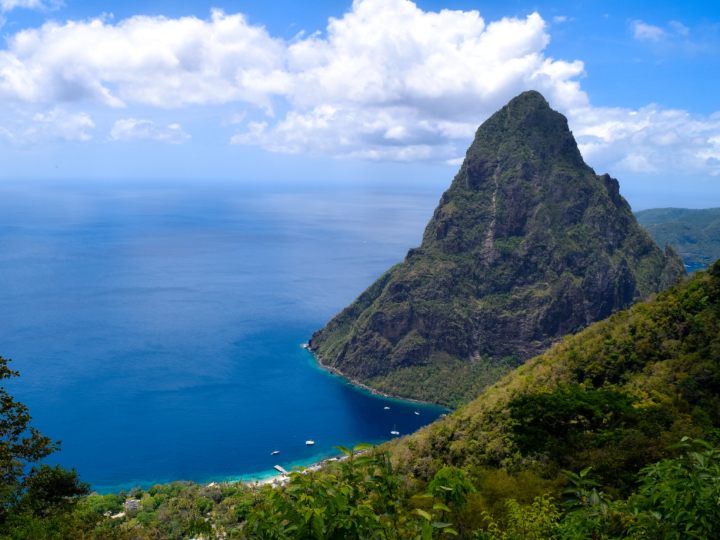 A view of the iconic Pitons in St. Lucia framed by lush greenery along the Tet Paul Nature Trail.